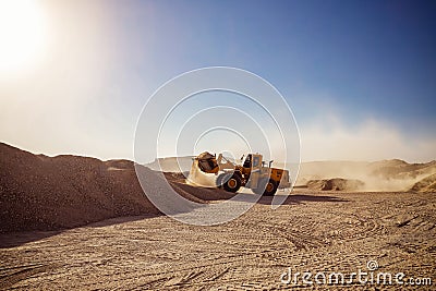 Bull Dozers and front loaders in working in quarry works Stock Photo