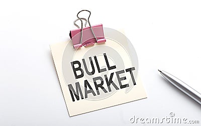 BULL MARKET text on sticker with pen on the white background Stock Photo