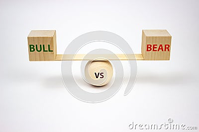 Bull vs bear lettering on wooden cubes scales on a white background. The concept of exchange trading of buyers and sellers. Stock Photo