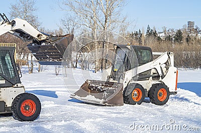 Bulldozer cleaning snow . Making road clean for car Stock Photo