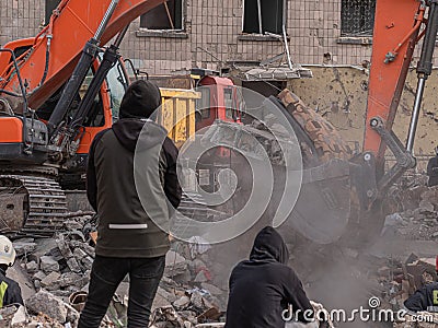 Bulldozer clears debris in search of people injured by air bombings. Editorial Stock Photo