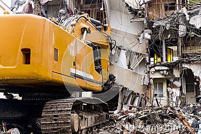 Bulldozer demolishes old buildings. demolition of a building in the harbor area Stock Photo