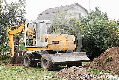 A bulldozer is digging on outdoors in an industrial area. Excavation. Belarus, Minsk region - August 13, 2020 Editorial Stock Photo