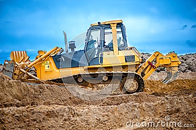 Bulldozer or excavator working with soil on construction site Stock Photo