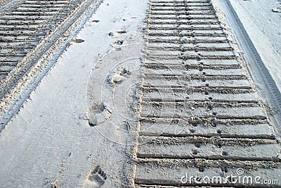 Bulldozer and human tracks in sand Stock Photo
