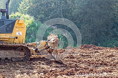 A bulldozer is leveling a piece of land Stock Photo