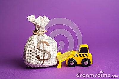 A bulldozer pushes a dollar money bag. Stock Photo