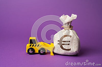 A bulldozer pushes a euro money bag. Stock Photo