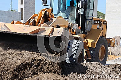 Bulldozer Pushing Dirt at Construction Site Stock Photo