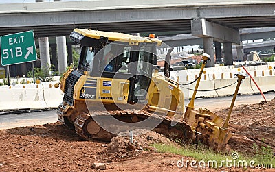 A bulldozer at work on a highway ramp Editorial Stock Photo