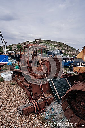 Bulldozers at Hastings fishing boats on the beach at Rock-a-Nore Editorial Stock Photo