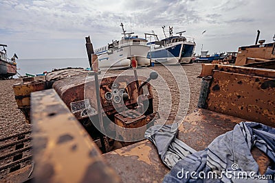 Bulldozers at Hastings fishing boats on the beach at Rock-a-Nore Editorial Stock Photo