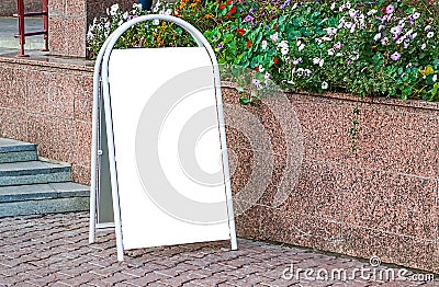 Bulletin Board, advertising, portable street stand poster with blank white space for text near flower beds Stock Photo