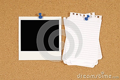 Polaroid photo frame with torn notepaper pinned to cork background, copy space Stock Photo