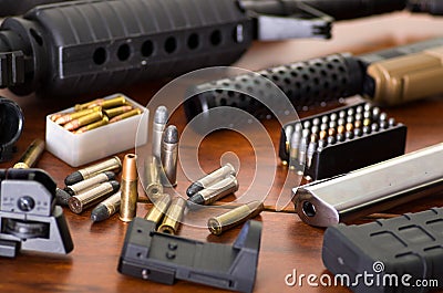 Bullets and a firearm. Bullets are a projectile expelled from the barrel of a firearm, on wooden table Stock Photo