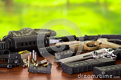 Bullets and a firearm. Bullets are a projectile expelled from the barrel of a firearm, on wooden table Stock Photo