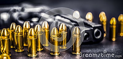 Bullets and handcuffs. Close-up of 9mm pistol. Gun and weapon with bullets amunition on black backround. Top view. Stock Photo