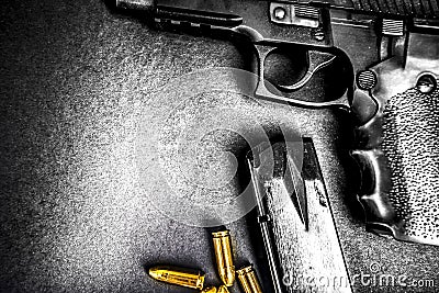 Bullets and handcuffs. Close-up of 9mm pistol. Gun and weapon with bullets amunition on black backround. Top view. Stock Photo