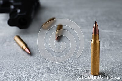 Bullets and handgun on light grey table, closeup. Space for text Stock Photo