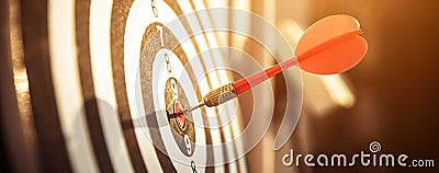 Bullseye or dart board has dart arrow throw hitting the center of a shooting target Stock Photo