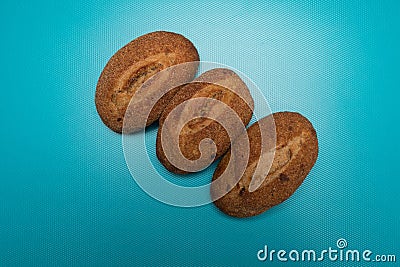 Bun studio image. Fresh buns on a blue background. Buckwheat Bread. Buns made from rye flour. Stock Photo