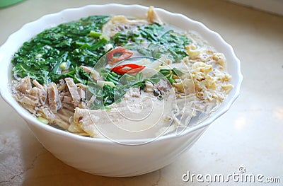 Bun Thang - traditional vietnamese dish with shredded chicken, ham and eggs which is garnished by chopped cilantro. Stock Photo