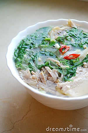 Bun Thang - traditional vietnamese dish with shredded chicken, ham and eggs which is garnished by chopped cilantro. Stock Photo