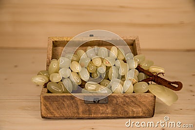 A bunch of artificial grapes in a wooden chest Stock Photo