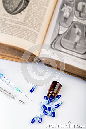Bunch of blue pills with glass ampoules, injection and thermometer Stock Photo