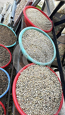 A bunch of bowls filled with different kinds of stones. Stock Photo