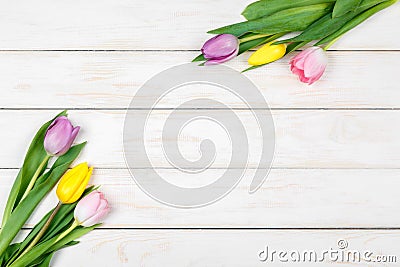 Bunch of colored tulips lying on a white wooden background Stock Photo