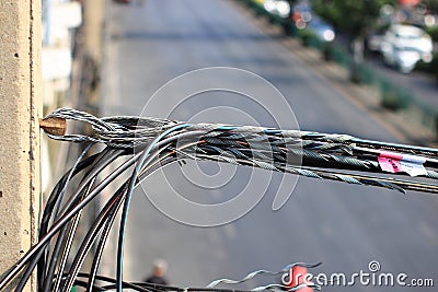 bunch of electrics and communication wires, wires on the pole, The chaos of cables and wires on an electric pole Stock Photo