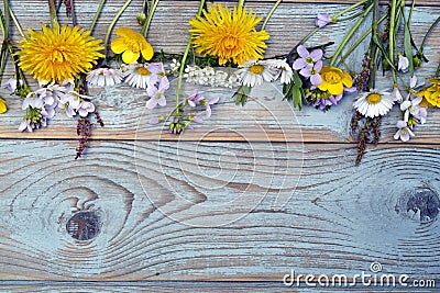Bunch of fieldflowers,daisies, buttercups, Pentecostal flowers, dandelions on a oldwooden background with empty copy space Stock Photo
