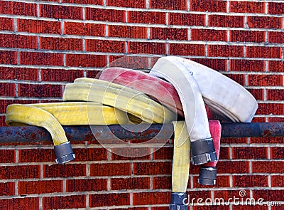 Bunched Fire Hoses on Pipe Rack Stock Photo