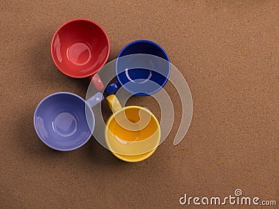 Range of four cups of coffee together on the sand background Stock Photo