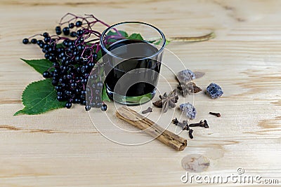 Bunch of fresh elderberries with juice and spices Stock Photo
