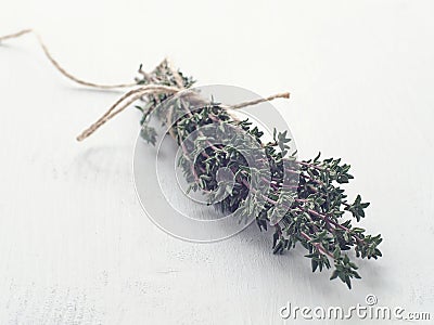 Bunch of fresh garden thyme arranged on white wooden table. Selective focus. Stock Photo