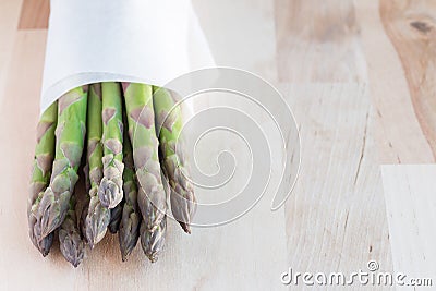 Bunch of fresh green asparagus on wooden table, horizontal, copy Stock Photo