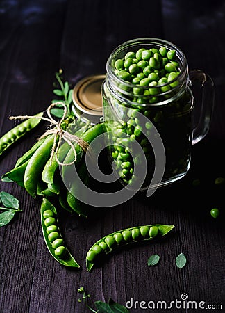 Bunch of fresh mature pods of green peas tied with a rope near. Stock Photo