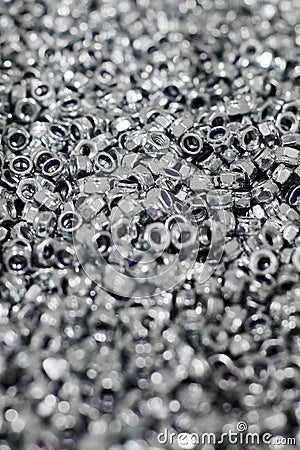 Bunch of galvanized hexagon locknuts for bolts, fasten multiple parts together, hardware fasteners Stock Photo