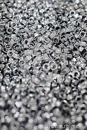 Bunch of galvanized hexagon locknuts for bolts, fasten multiple parts together, hardware fasteners Stock Photo
