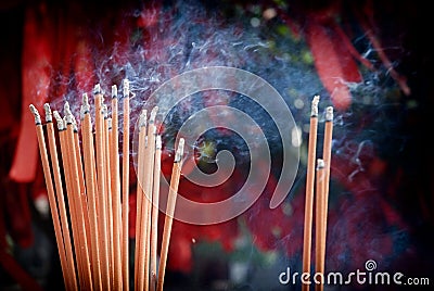 A bunch of glowing incense sticks Stock Photo