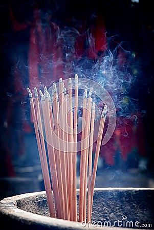 A bunch of glowing incense sticks Stock Photo