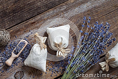 Bunch of lavender flowers and three sachets filled with lavender Stock Photo