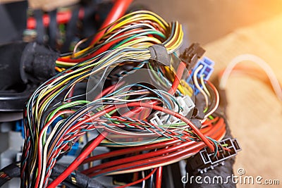 A bunch of multi-colored electrical wires - blue, green, red and yellow, interconnected in the nodes of the car when the network Stock Photo