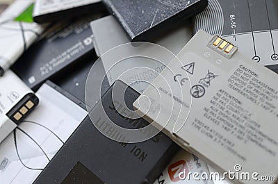 Bunch of old used mobile phone batteries. Recycling electronics was sold in the market cheap Editorial Stock Photo