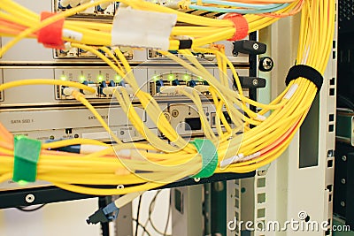 A bunch of optical Internet cables connected to the main router. Powerful network equipment located in the server room datacenter Stock Photo