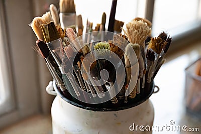 Bunch of paint brushes in metal bucket close up Stock Photo