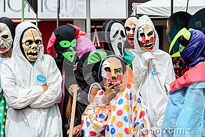 a bunch of people wearing halloween costumes and masks standing together Editorial Stock Photo