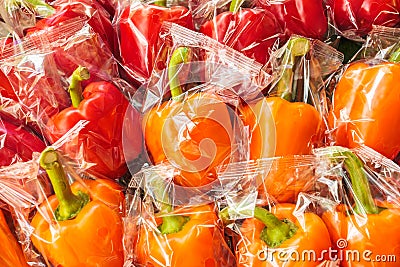 Bunch of plastic wrapped bell peppers Stock Photo